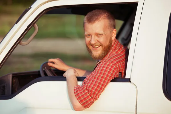 Driver in a red shirt while driving