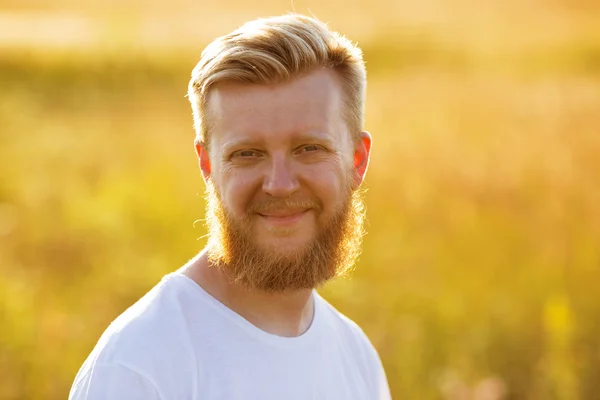 Smiling man with a big red beard