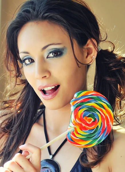 Woman holding colorful candy lollypop