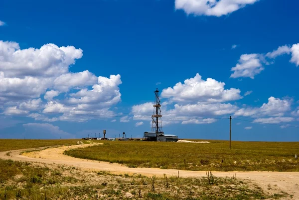 Oil tower among a fields