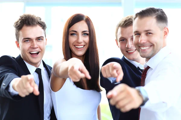 Group of executives pointing at you