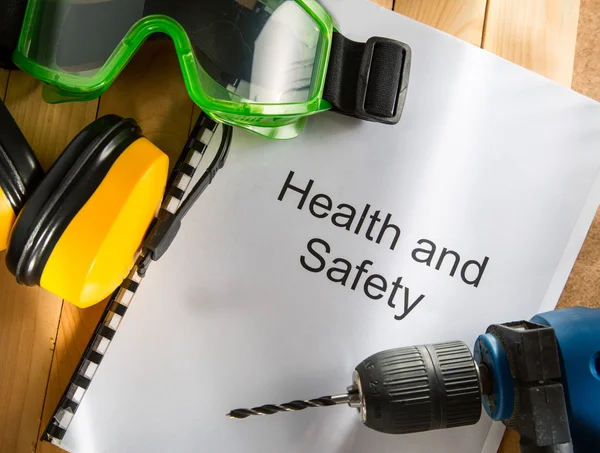 Health and safety Register with goggles, drill and earphones