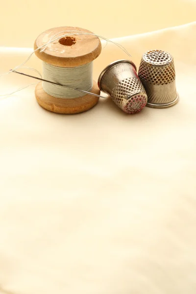 Sewing thimbles, bobbin and needle