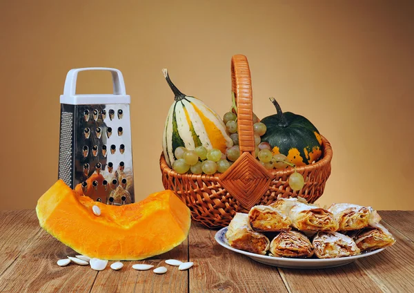 Decorative pumpkins in wicker baskets and pastries