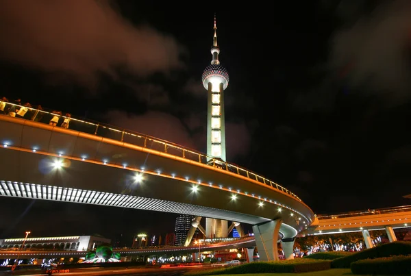 A View of the Oriental Pearl Television Tower and Raised Walkway at Night