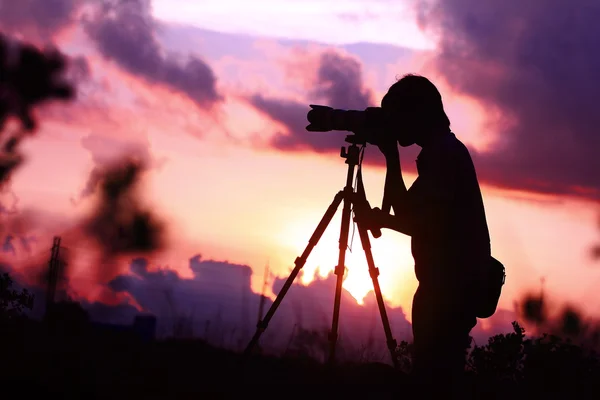 Silhouette of young photographer