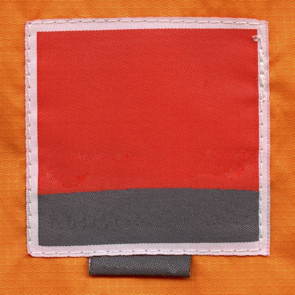 Red-black textile label isolated on yellow