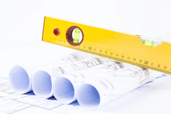 Construction level and blueprints — Stock Photo #38354169