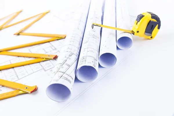 Rolls of architectural plans and construction tools — Stock Photo #38358411