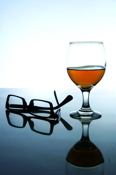 Alcoholic Drink and a pair of eyeglasses