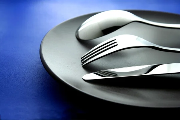 Spoon, fork, knife and plate