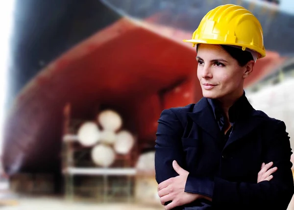 Naval engineer against container ship at drydock