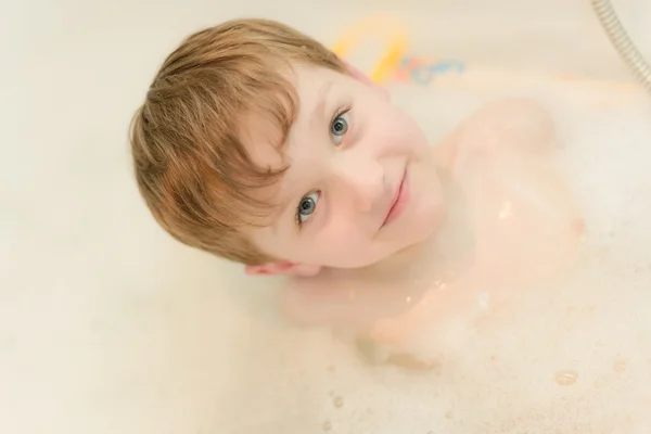 4 year happy old boy bathes in the tub