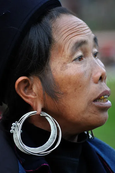 A Black Hmong woman wearing silver earring in Sapa, Vietnam