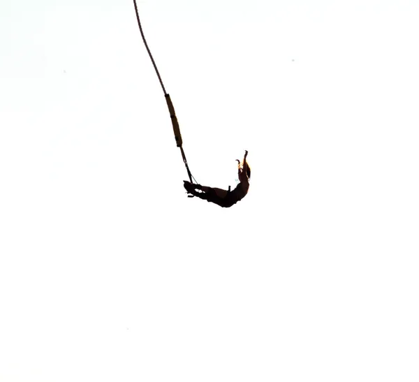 Silhouette of a bungee jumping woman isolated on white background