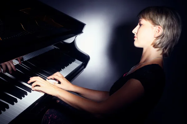 Piano playing pianist player. Woman with grand piano