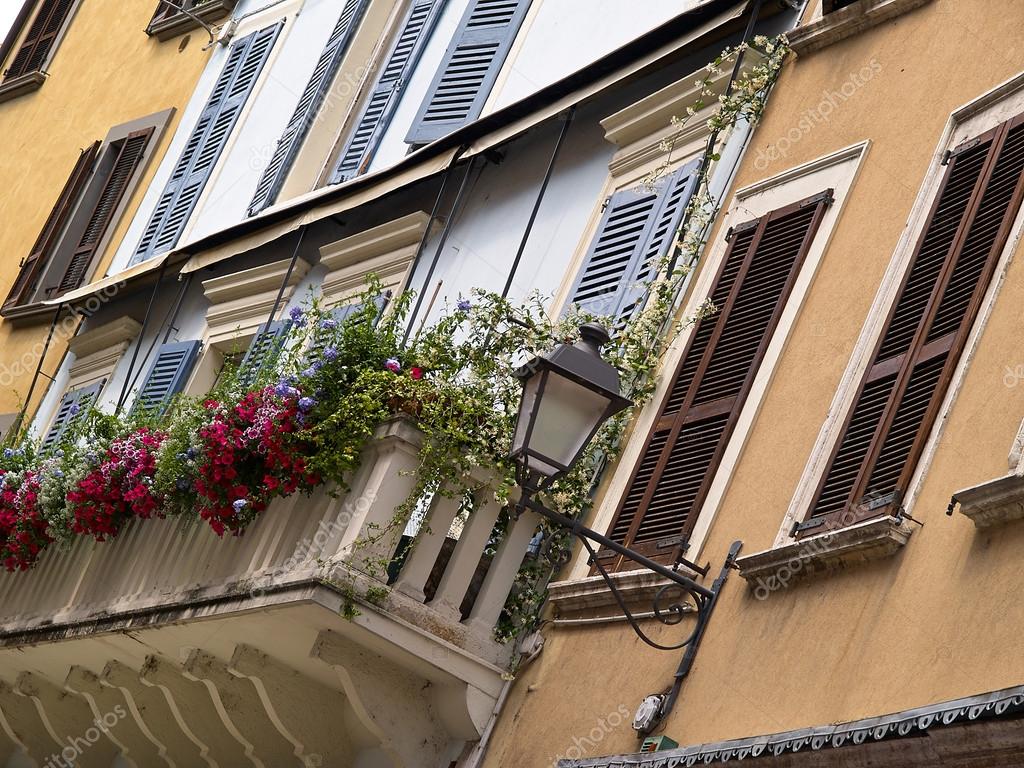 Stock photograph of typical italian house balcony with flowe.
