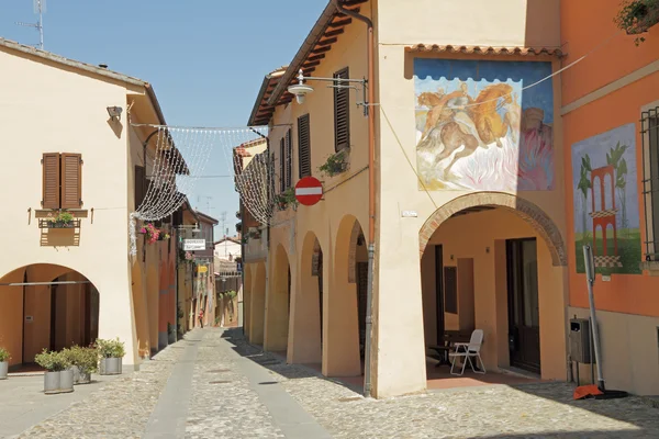 Street with arcades and murals in Dozza , Italian small town kno