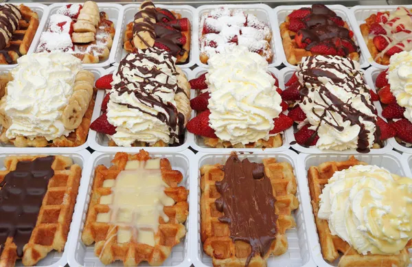 Variety of Belgian waffles on street stall in Brussels, Belgium,