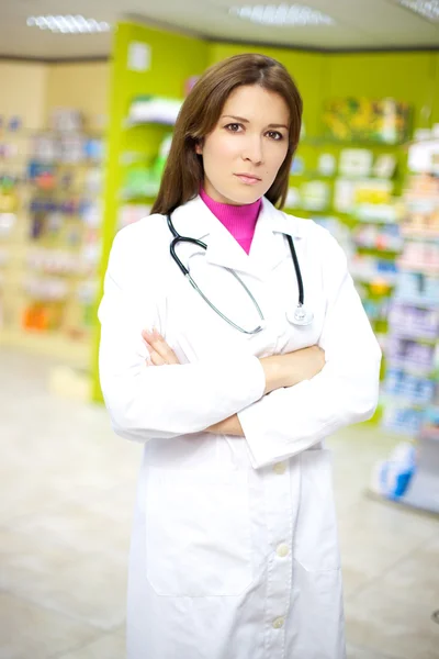 Serious female doctor in pharmacy