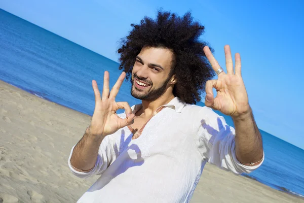 Handsome man ok sign on the beach