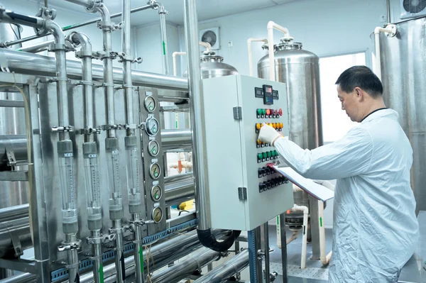 Pharmaceutical factory technician at work