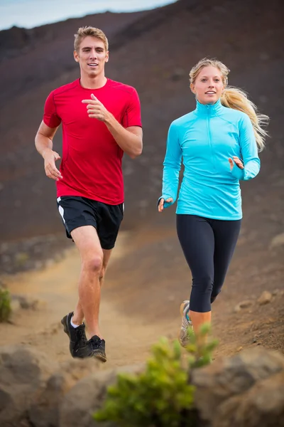 Fitness sport couple running jogging outside on trail