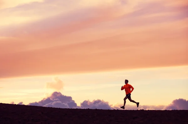 Male runner silhouette, running into sunset — Stock Photo #34826359