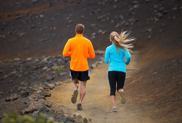 Fitness sport couple running jogging outside on trail