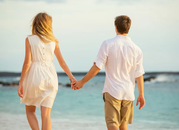 Young couple in love on the beach sunset