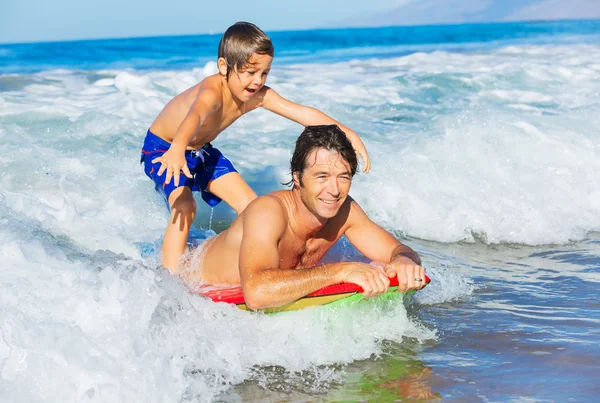 Father and Son Surfing Tandem Togehter Catching Ocean Wave, Care