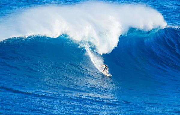 Surfer riding giant wave