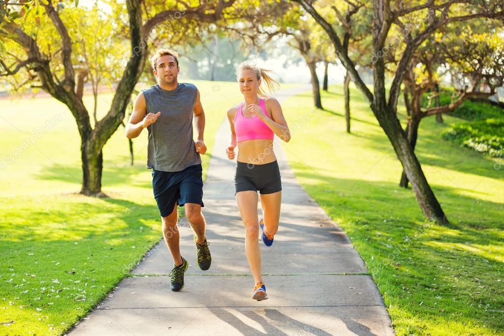 Couple running together in the park — Stock Photo © EpicStockMedia