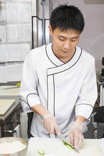 Japanese chef with a plate of sushi