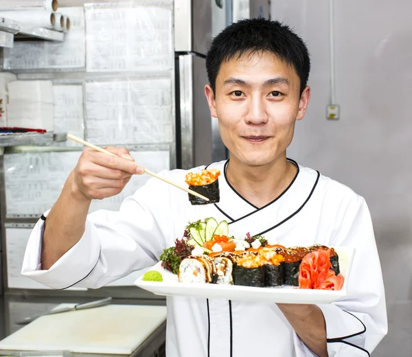 Japanese chef with a plate of sushi