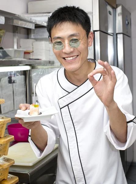 Japanese chef with a plate of sushi