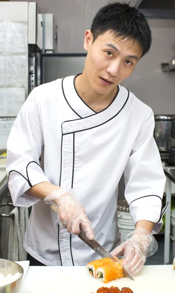 Japanese chef with a plate of sushi