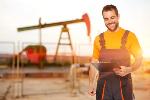 Refinery worker reads the data from the black plates