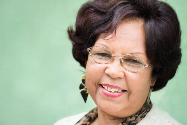 Portrait of happy elderly black lady with eyeglasses smiling