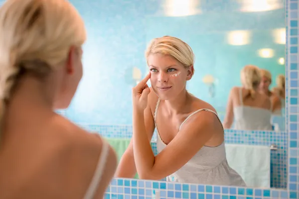 Female beauty, young woman applying lotion on face at home — Stock Photo #13887199