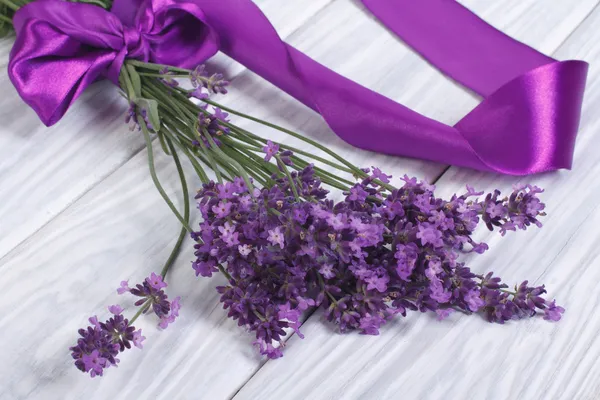 Bouquet of fresh lavender flowers with purple ribbon