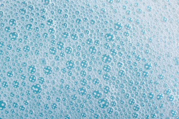 Background of suds with bubbles blue close up