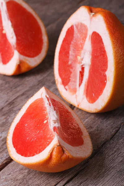 Large pieces of red grapefruit on the old wooden
