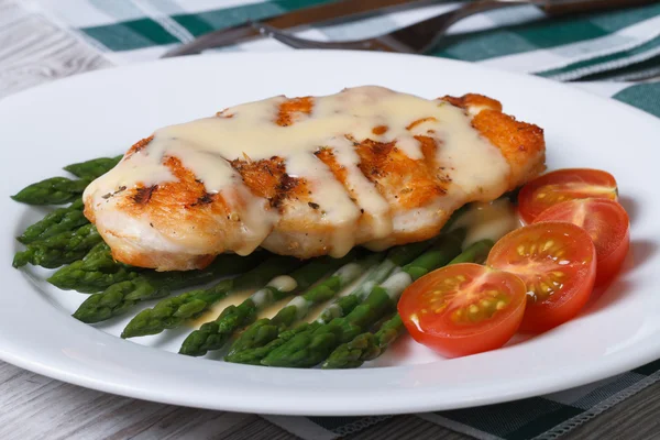 chicken breast with asparagus and Hollandaise sauce closeup