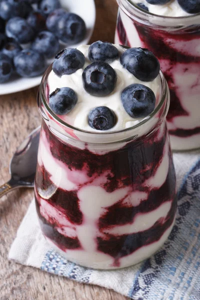 Yogurt with blueberries vertical view from above