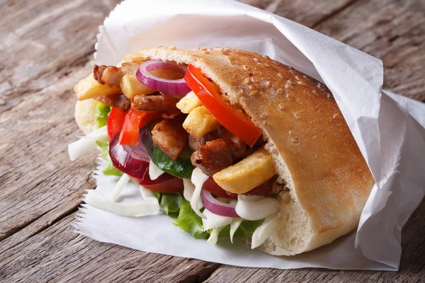 Doner kebab with meat, fried potatoes and vegetables