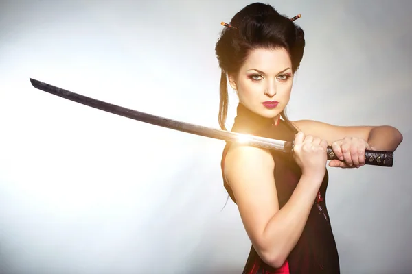 Woman with japan sword katana in hands