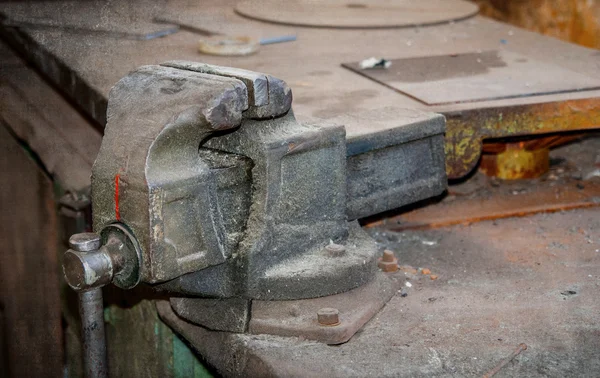 Old vise on a workshop table