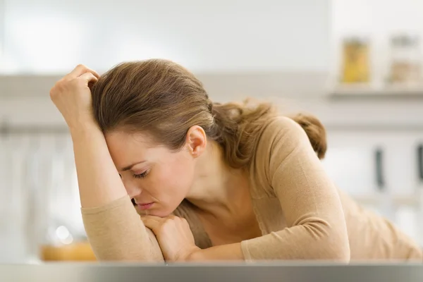 Stressed young housewife in kitchen