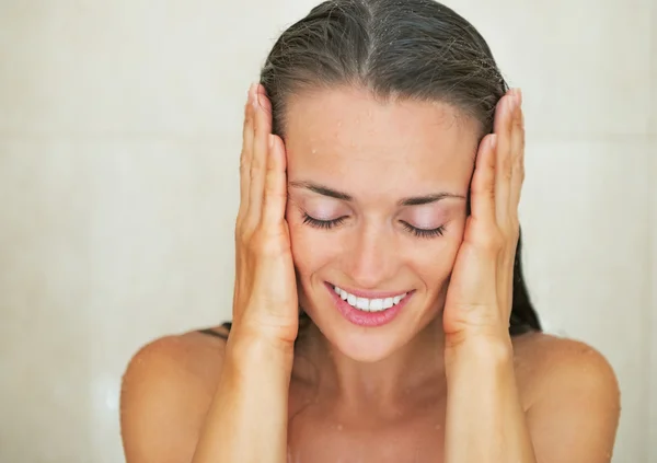 Happy young woman in shower